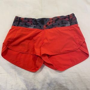 Orange Lululemon shorts with patterned band